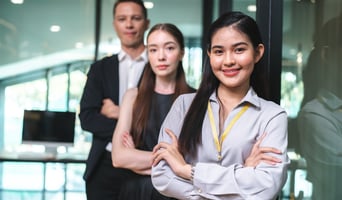 Portrait of smart young Asian business woman, successful female employee smiling with happy job, financial woman satisfied with the results of her work achievement in modern office