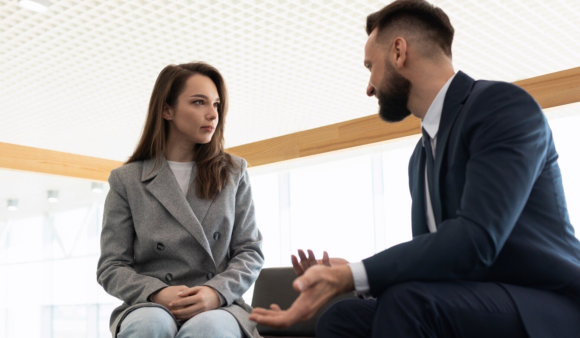 Man talking to a woman who is engaged in active listening