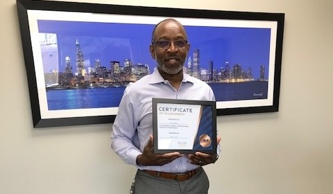 A. Pierre Poinsett holing his BIA certificate