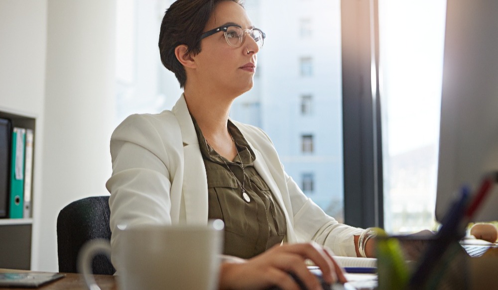 Confident and determined professional using a computer