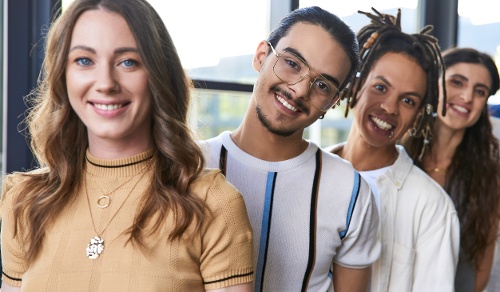group portrait of diverse multiethnic team in stylish casual attire smiling at camera in office