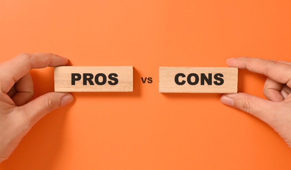 Pros and cons text on wooden blocks with orange background